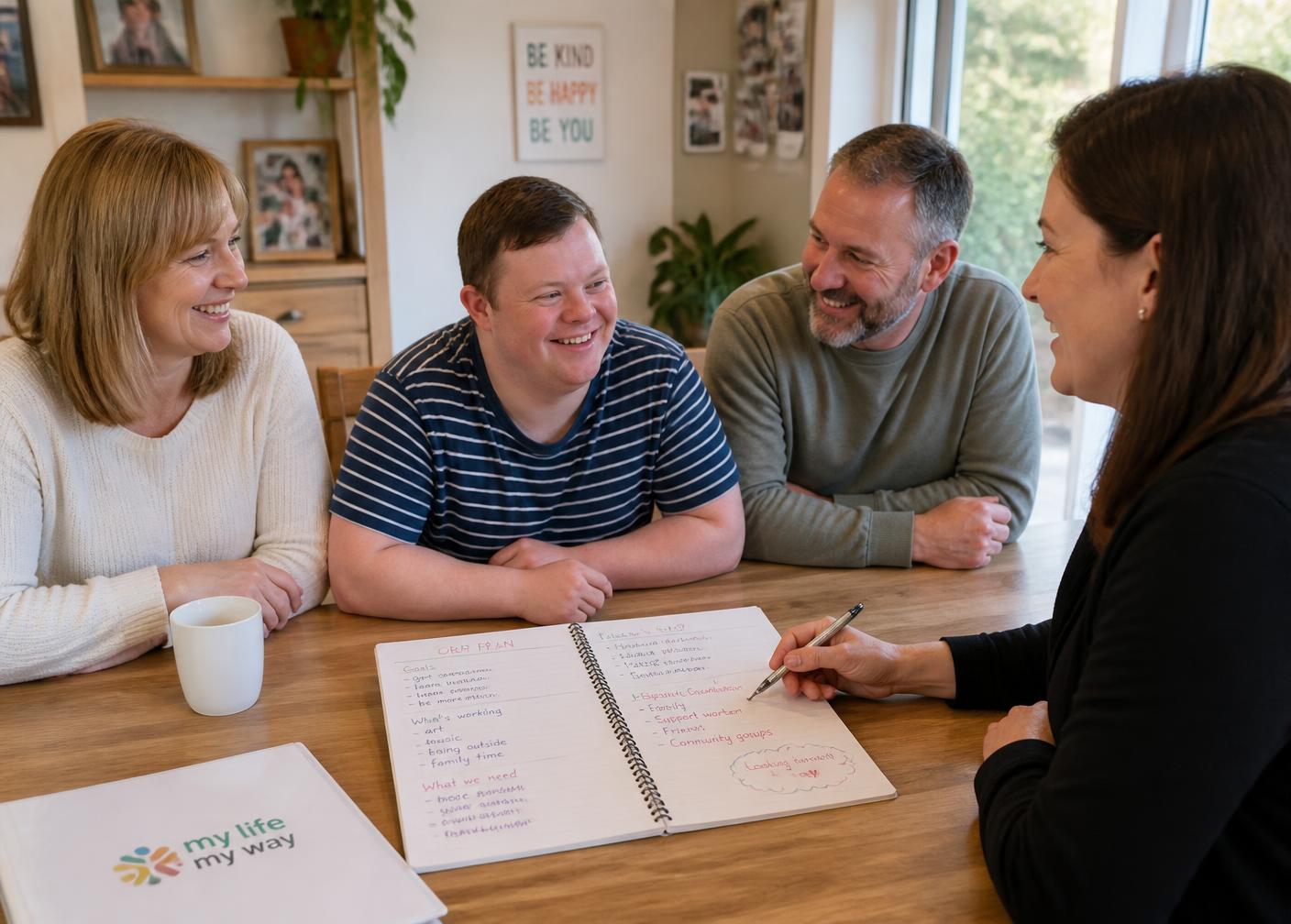 A support coordinator meeting with family members and a young adult with a disability around a table.